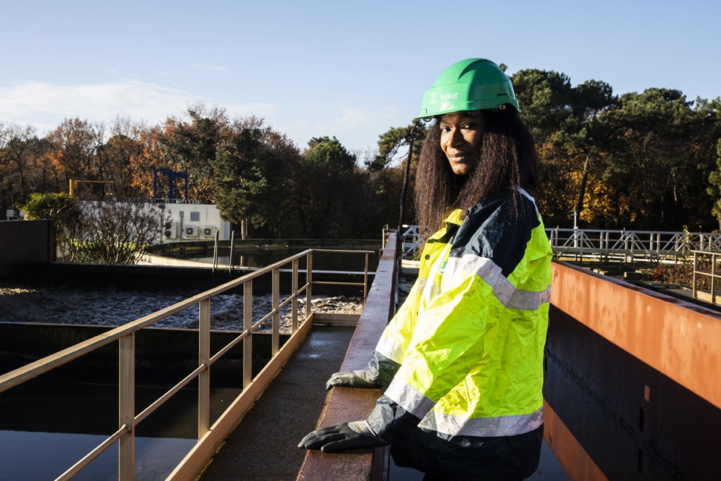 A woman standing on a wastewater treatment plant in uniform